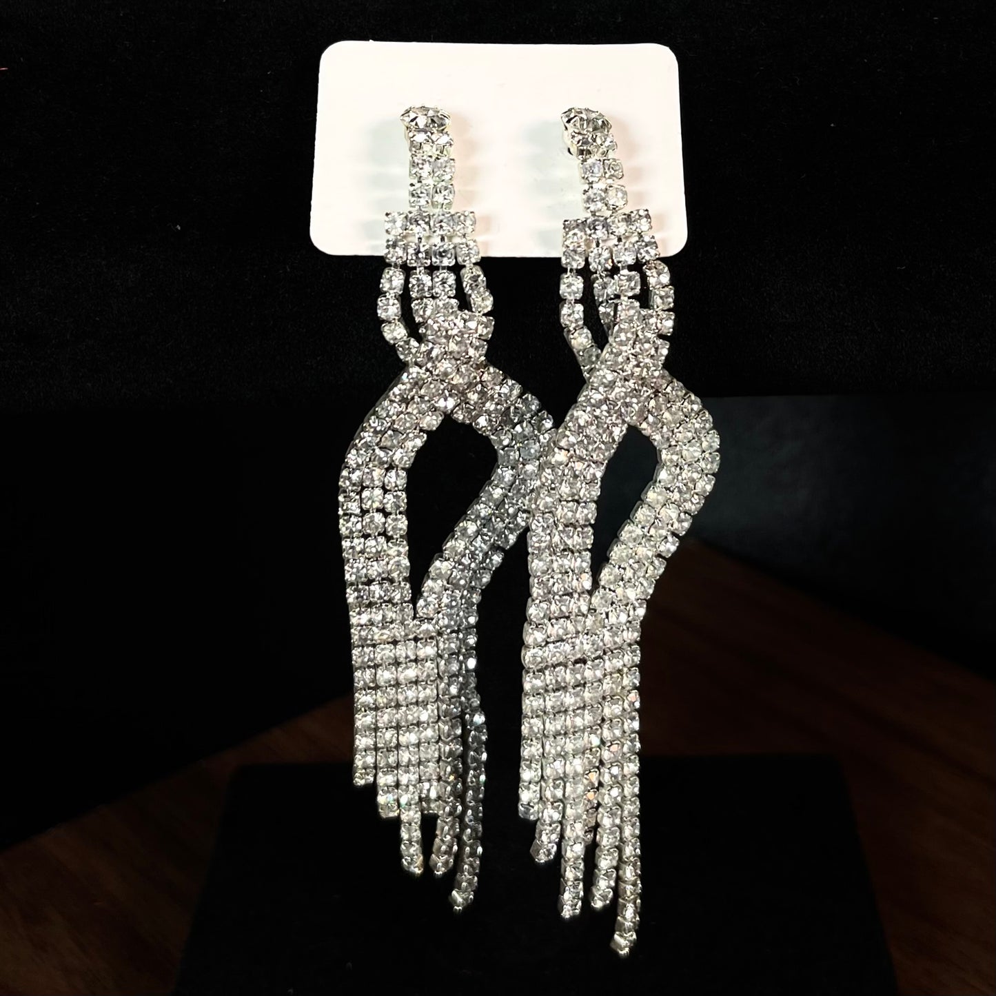 Long silver crystal fringe chandelier earrings with knotted rhinestone top and cascading tassel strands on white card display — DubyAllure Velvet Rain